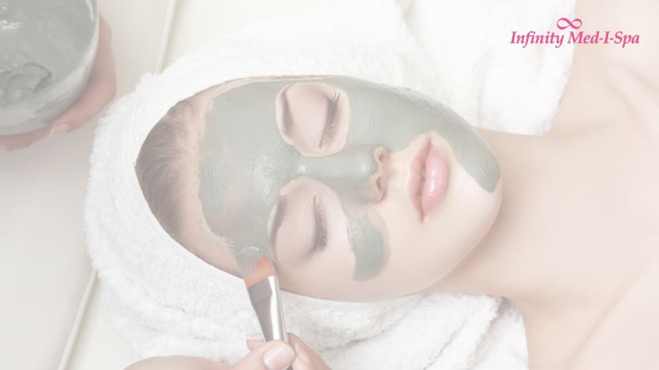 woman with facial mud mask being applied