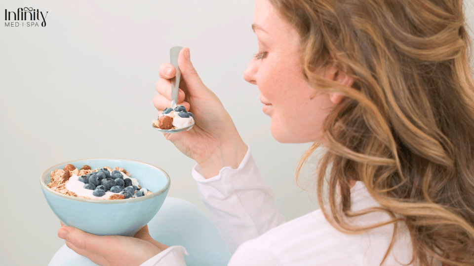 Woman eating fruit for healthy skin.